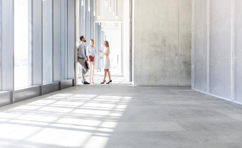 Financial professionals meeting in a hallway