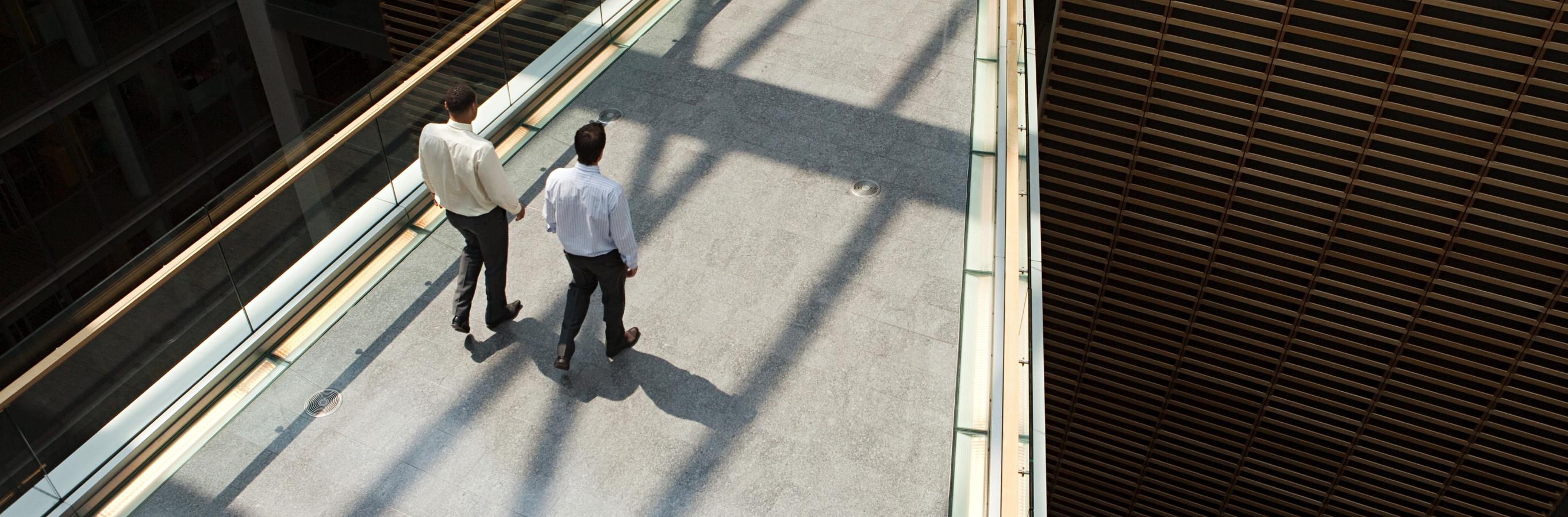 Investment professionals walking together in a breezeway